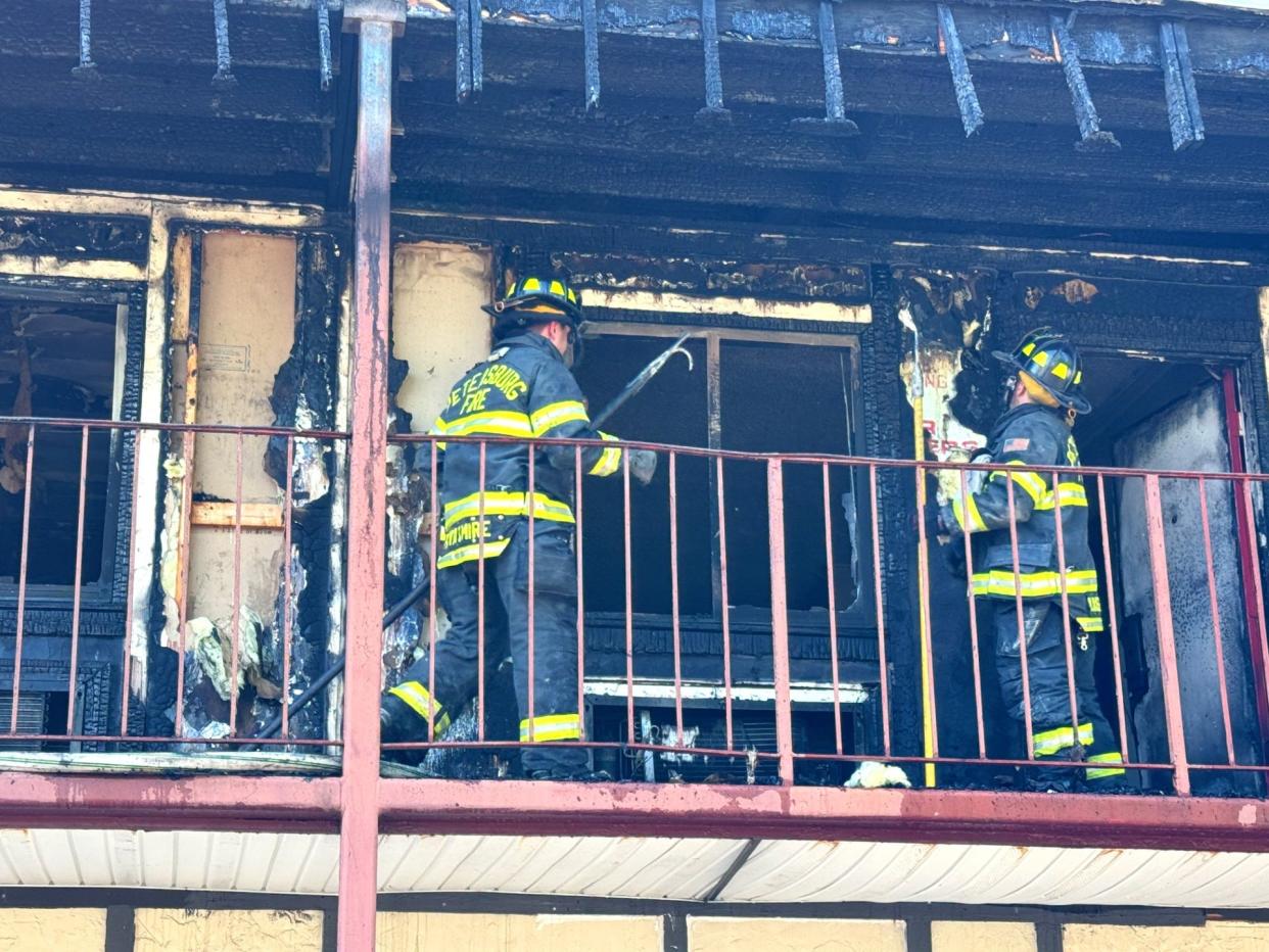 Firefighters examine the damage caused by a blaze at the American Inn on County Drive in Petersburg Tuesday, April 23, 2024. There were no serious injuries but 29 families were displaced.