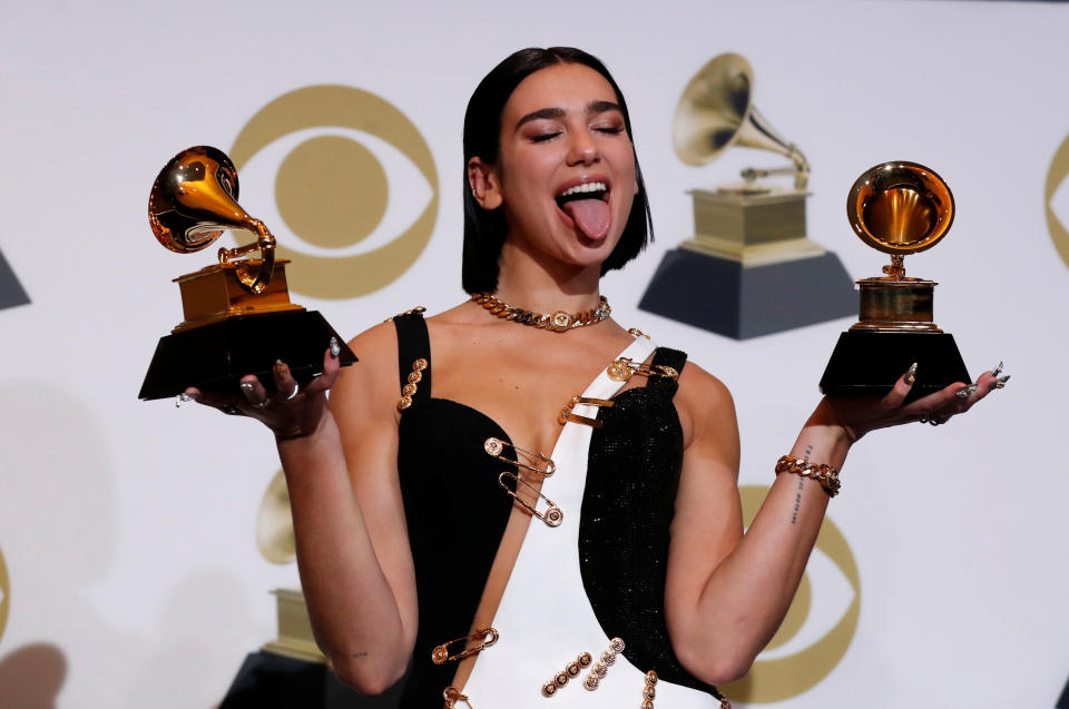 Dua Lipa holding Grammy Awards