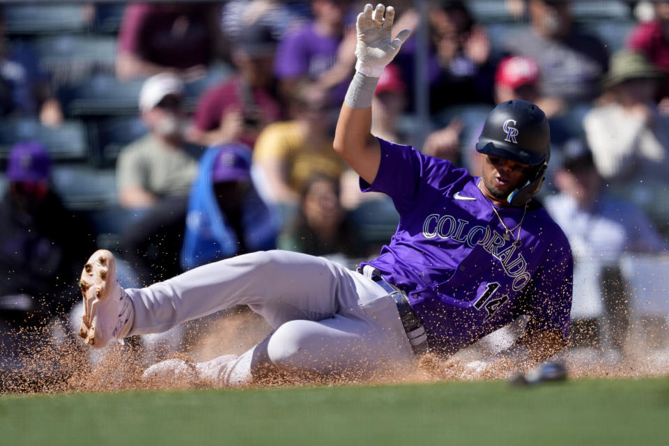 Colorado Rockies' Ezequiel Tovar scores an a base hit by Brenton Doyle against the Los Angeles Angels during the second inning of a spring training baseball game, Friday, March 8, 2024, in Tempe, Ariz. (AP Photo/Matt York)