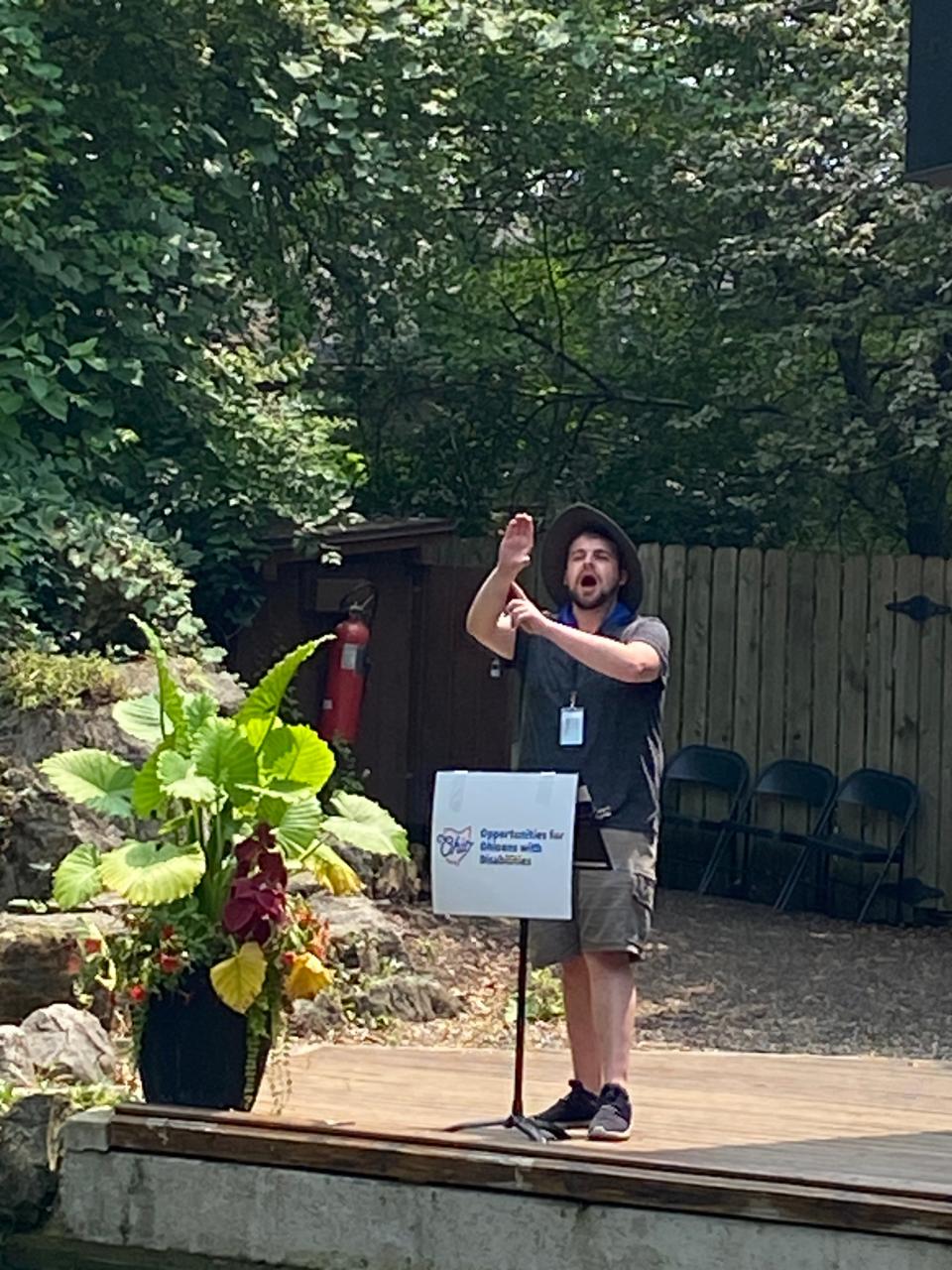 An American Sign Language interpreter at a Natural Resources Park Great Lakes Timber show at the 2023 Ohio State Fair.