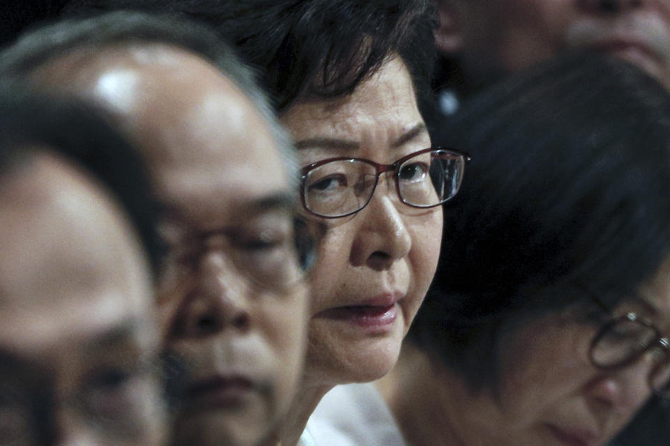 Hong Kong Chief Executive Carrie Lam listens to a question during a community dialogue with selected participants at the Queen Elizabeth Stadium in Hong Kong, Thursday, Sept. 26, 2019. Scores of protesters chanted slogans outside the venue as Lam began the town hall session Thursday aimed at cooling down months of demonstrations for greater democracy in the semi-autonomous Chinese territory. (AP Photo/Kin Cheung)