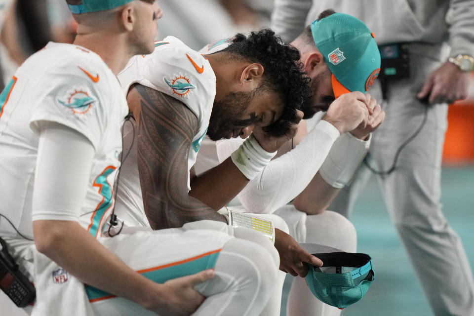 Miami Dolphins quarterback Tua Tagovailoa (1) sits on the sidelines during the second half of an NFL football game against the Buffalo Bills, Sunday, Jan. 7, 2024, in Miami Gardens, Fla. (AP Photo/Wilfredo Lee)