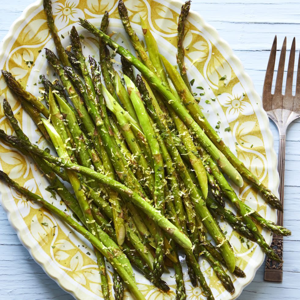 lemon roasted asparagus on yellow flower platter