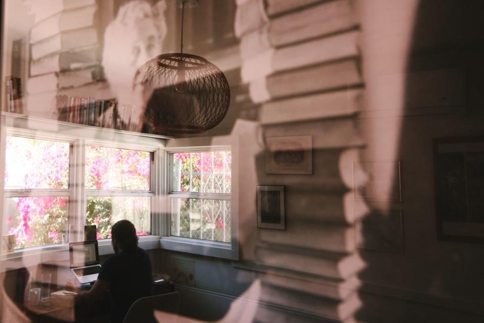 A man is reflected in a photograph of Agatha Christie