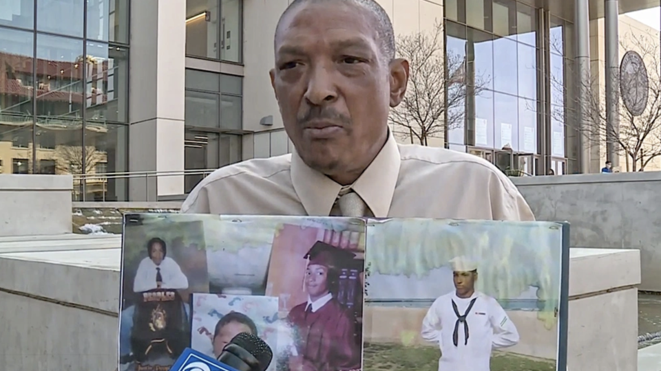 Maurice Peoples on March 18, 2022, displays photos of his son, Justin, who was murdered three nights before.  / Credit: CBS San Francisco