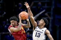 Pittsburg State guard Tyler Hawkins (24) looks to pass as he is pressured by Kansas State's Mark Smith (13) during the second half of an exhibition NCAA college basketball game Thursday, Nov. 4, 2021, in Manhattan, Kan. Kansas State won 78-59. (AP Photo/Charlie Riedel)