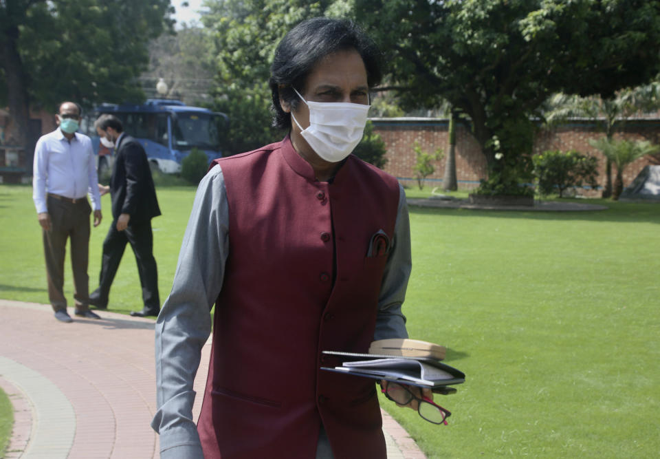 Ramiz Raja, center, former Pakistan cricketer and candidate for the chairman of Pakistan Cricket Board, arrives to attend PCB's governing board meeting, in Lahore, Pakistan, Monday, Sept. 13, 2021. Raja is set to become the new chairman of the country's cricket board. Prime Minister Imran Khan, in his role as patron of the Pakistan Cricket Board, nominated Raja to the governing board after Ehsan Mani declined to accept a short-term extension when his three-year term expired last week. (AP Photo/K.M. Chaudary)