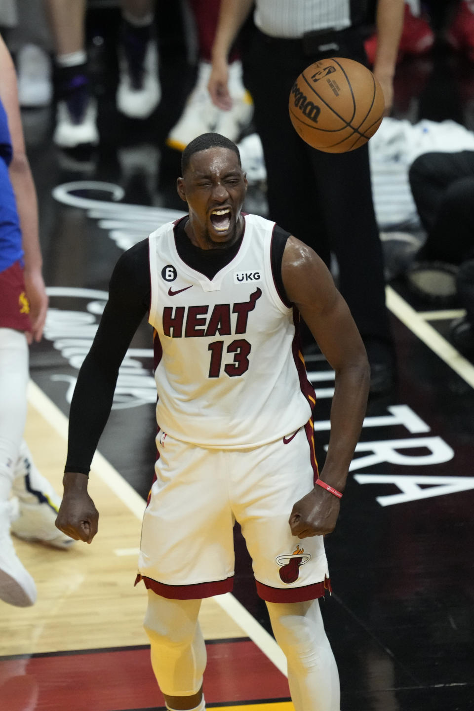 Miami Heat center Bam Adebayo (13) reacts after dunking the ball during the first half of Game 3 of the NBA Finals basketball game against the Denver Nuggets, Wednesday, June 7, 2023, in Miami. (AP Photo/Rebecca Blackwell)