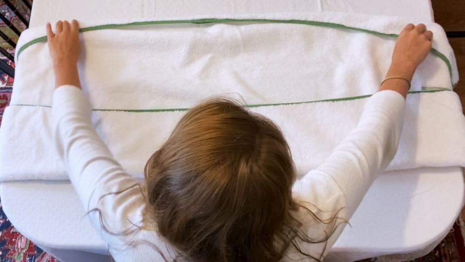 woman folding towel