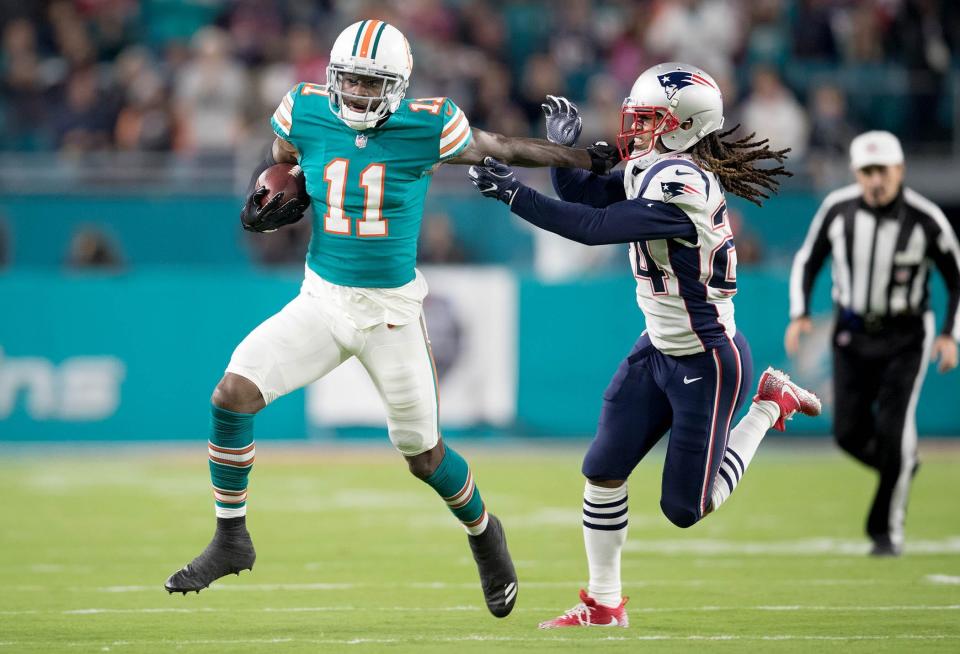 Then-Dolphins receiver DeVante Parker stiff arms Patriots cornerback Stephon Gilmore during the game on Dec. 11, 2017, in Miami Gardens, Fla.