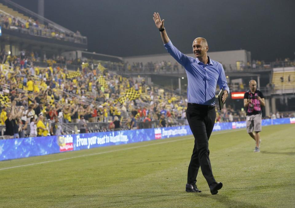 Crew coach Gregg Berhalter waves to fans following a game on Aug. 11, 2018.