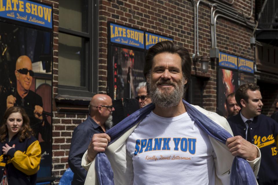 Comedian Jim Carrey shows off his shirt as he arrives at Ed Sullivan Theater in Manhattan as David Letterman prepares for the taping of tonight's final edition of "The Late Show" in New York