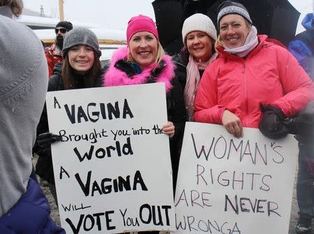 Park City resident Martina Costello (R), poses with friends as they hold up their signs during the Women's March protest at the Sundance Film Festival in Park City, Utah, U.S. January 21, 2017. REUTERS/Piya Sinha-Roy