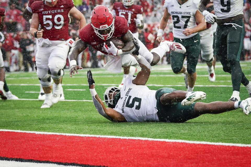 Rutgers running back Kyle Monangai (5) leaps into the end zone to score a touchdown during the fourth quarter of an NCAA college football game against Michigan State Saturday Oct. 14, 2023, in Piscataway, N.J. (AP Photo/Bryan Woolston)