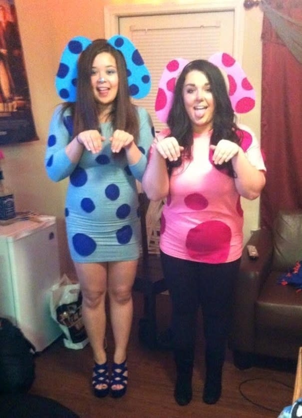 Two people wearing blue and pink with dog ears and spots on their body