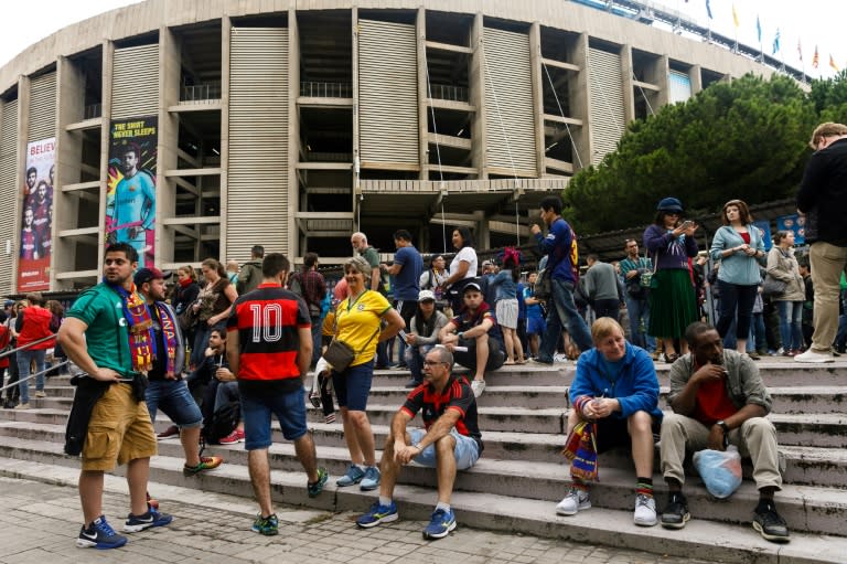 Football fans sit outside the Camp Nou after the decision to play behind closed doors on October 1, 2017