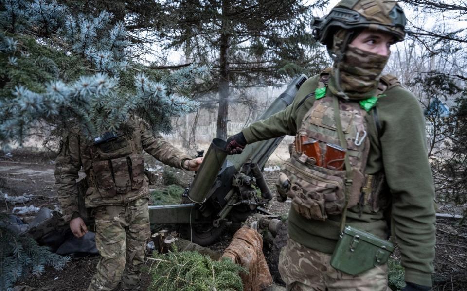 Ukrainian soldiers of the 1st Presidential Brigade of the Ukraine National Guard fire artillery shells with a decades-old 105mm Italian pack howitzer at Russian positions on February 16, 2024 in the Kreminna direction at an unspecified location, Ukraine.