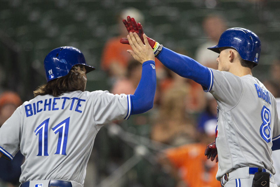 Sep 17, 2019; Baltimore, MD, USA; Toronto Blue Jays second baseman Cavan Biggio (8) high fives shortstop Bo Bichette (11) at home plate after hitting a two run home run against the Baltimore Orioles at Oriole Park at Camden Yards. Mandatory Credit: Tommy Gilligan-USA TODAY Sports