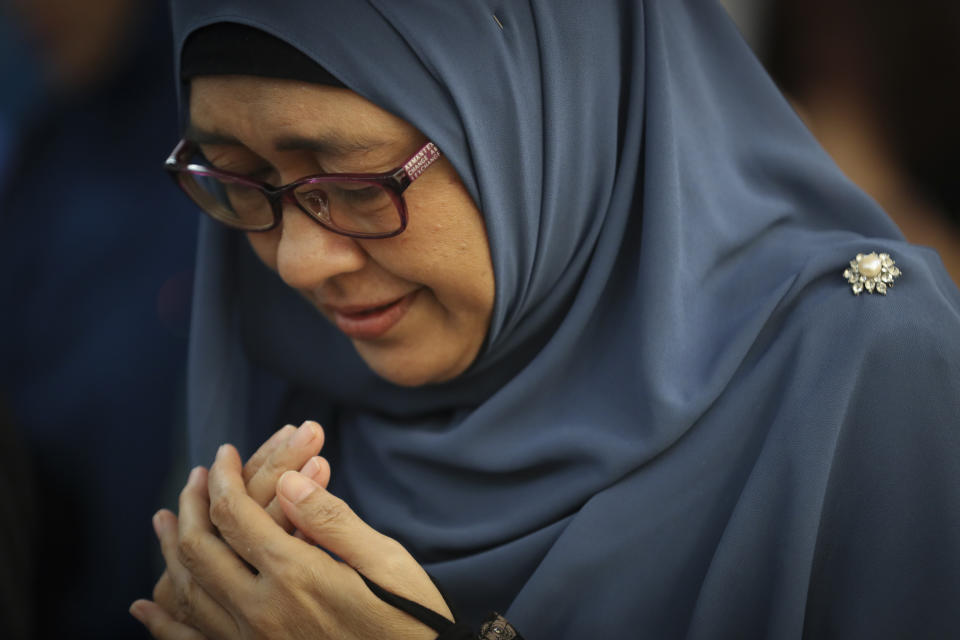 A woman prays as friends and family of victims from Malaysia Airlines Flight MH17 plane crash attend a ceremony marking the fifth anniversary of the tragedy in Kuala Lumpur, Malaysia, Wednesday, July 17, 2019. Five years after a missile blew Malaysia Airlines Flight 17 out of the sky above eastern Ukraine, relatives and friends of those killed gathered Wednesday in Kuala Lumpur and at a Dutch memorial to mark the anniversary. (AP Photo/Vincent Thian)