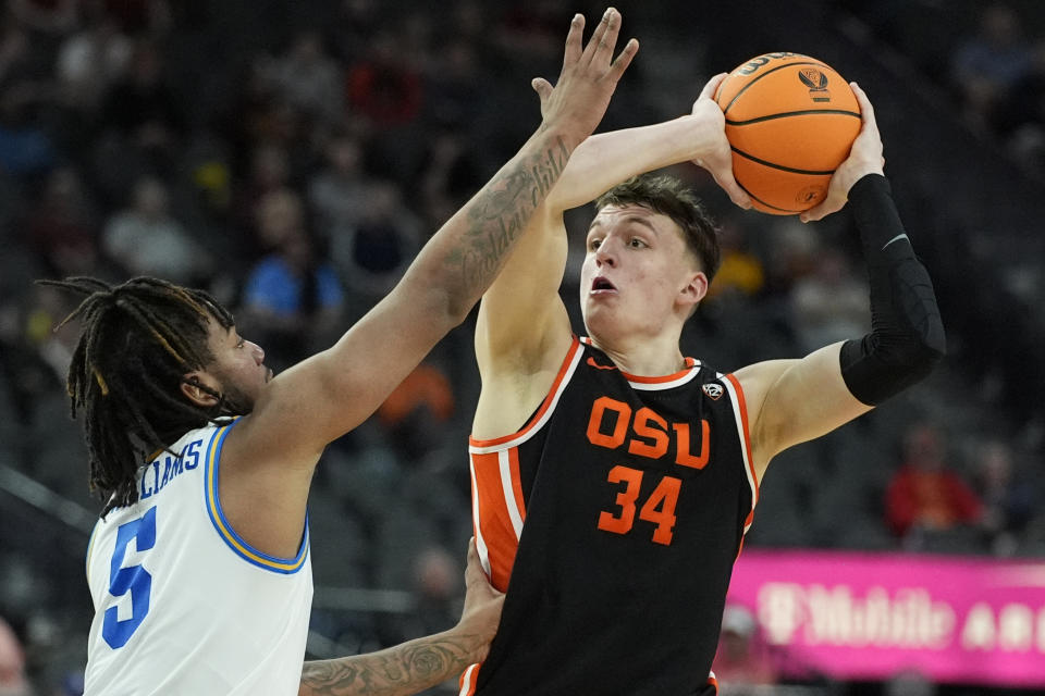 Oregon State forward Tyler Bilodeau (34) looks to shoot over UCLA guard Brandon Williams (5) during the second half of an NCAA college basketball game in the first round of the Pac-12 tournament Wednesday, March 13, 2024, in Las Vegas. (AP Photo/John Locher)