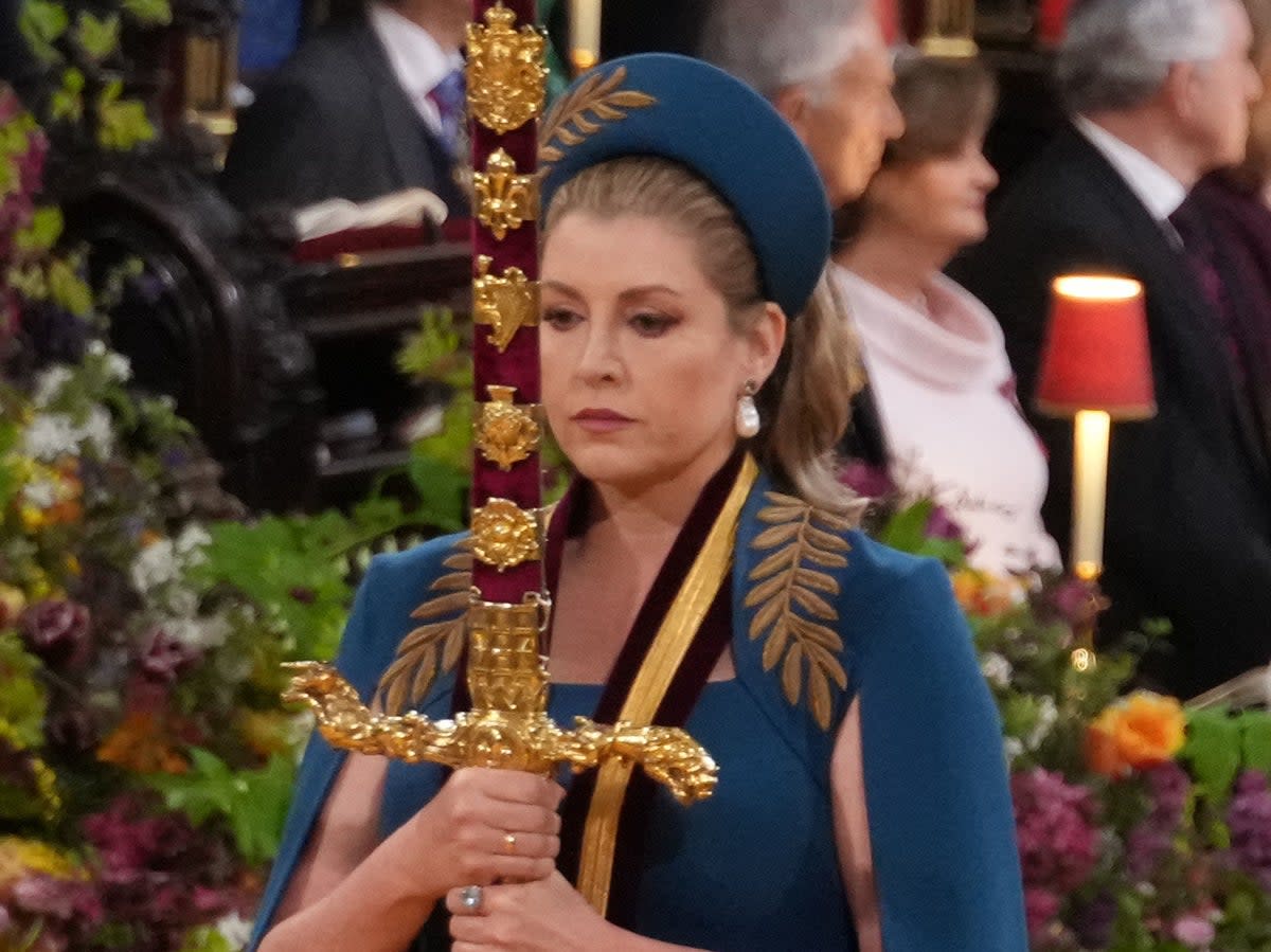 Mordaunt carrying the sword during King Charles’s coronation (PA)