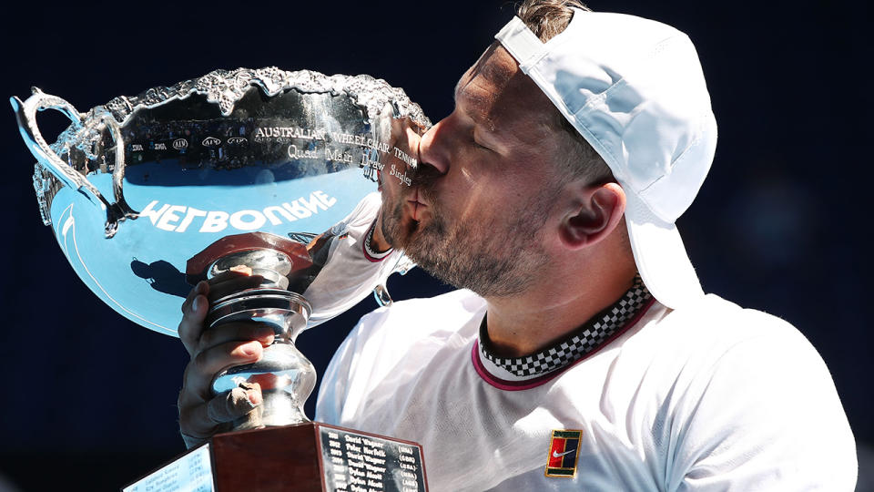 Dylan Alcott kisses the championship trophy. (Photo by Scott Barbour/Getty Images)