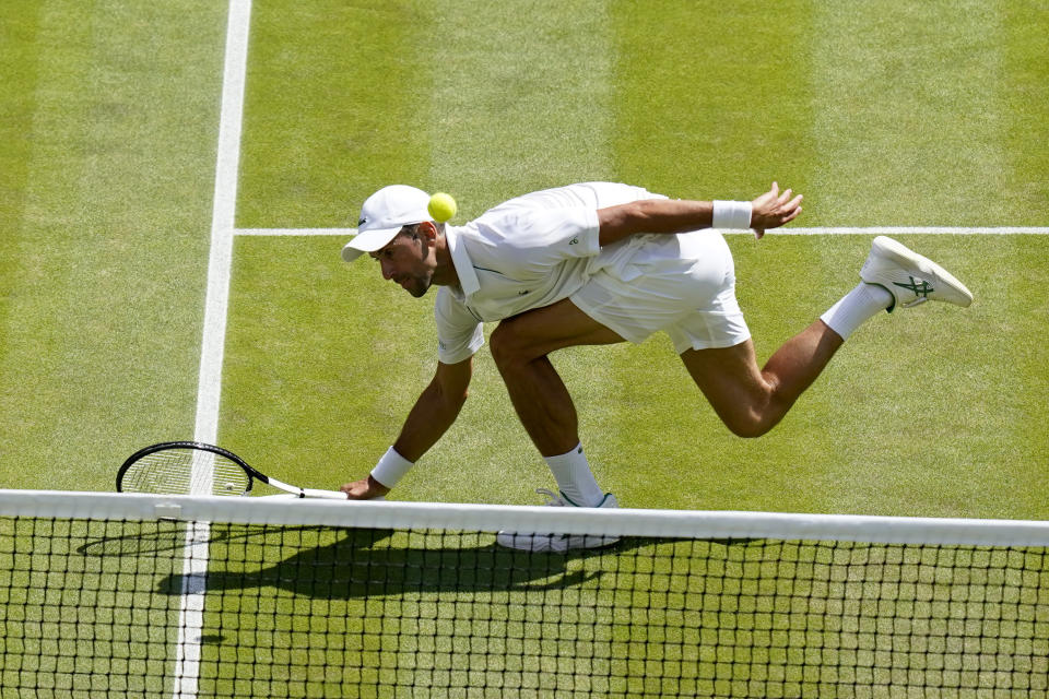 Serbia's Novak Djokovic returns to Australia's Nick Kyrgios in the final of the men's singles on day fourteen of the Wimbledon tennis championships in London, Sunday, July 10, 2022. (AP Photo/Gerald Herbert)