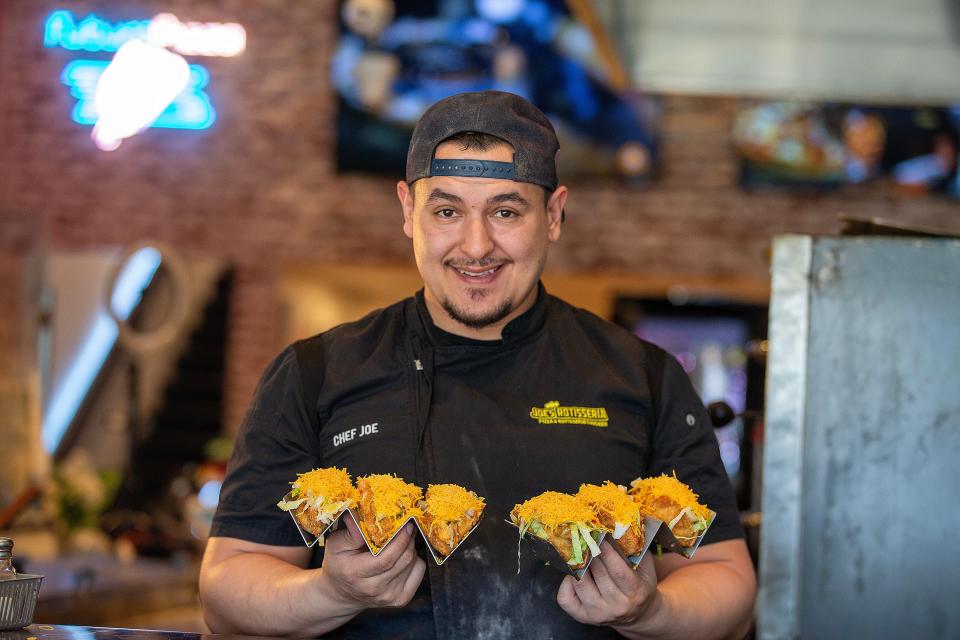 Joe Brignoni, owner of Joe’s Rotisseria in Asbury Park, creates taco empanadas, one prepared with beef and cheese, and the other with Buffalo chicken.