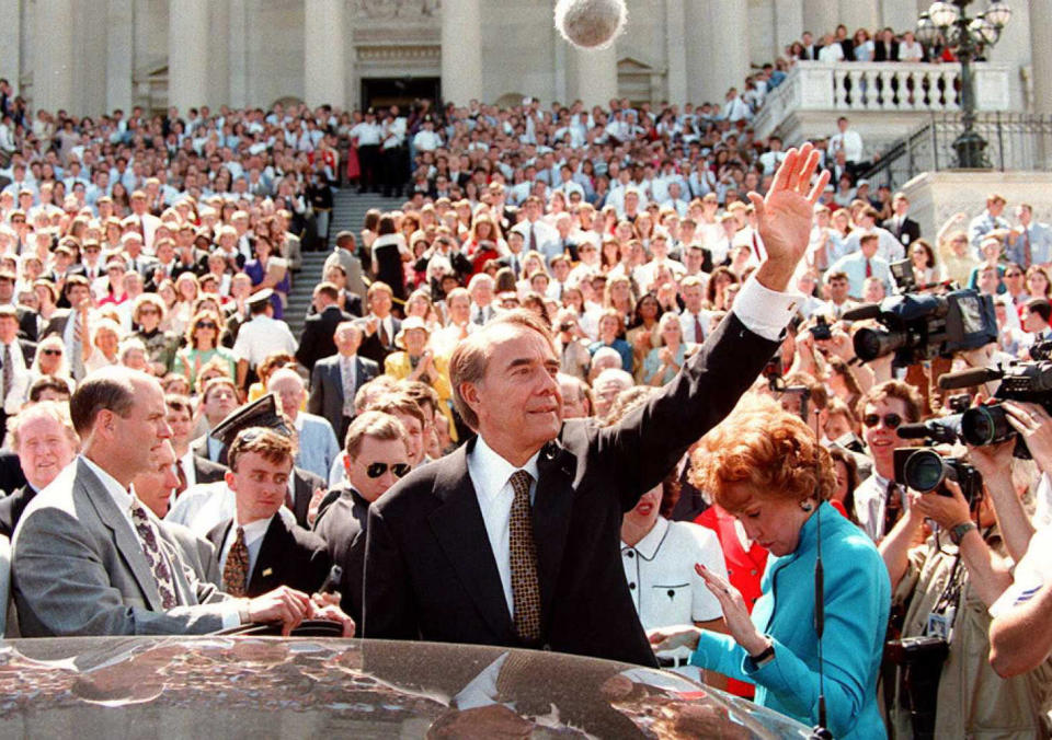 Retiring U.S. Sen. Bob Dole, R-Kansas, is surrounded by staffers and well-wishers as he prepares to leave the U.S. Capitol in Washington June 11, 1996. Dole ended his 35-year career in the Senate in order to devote his full attention to his presidential campaign. / Credit: Richard Ellis/AFP/Getty Images