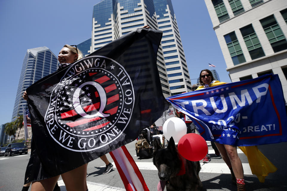 QAnon conspiracy theorists hold signs and protest the California lockdown due to the coronavirus (COVID-19) pandemic on May 01, 2020 in San Diego, California.  (Sean M. Haffey/Getty Images)