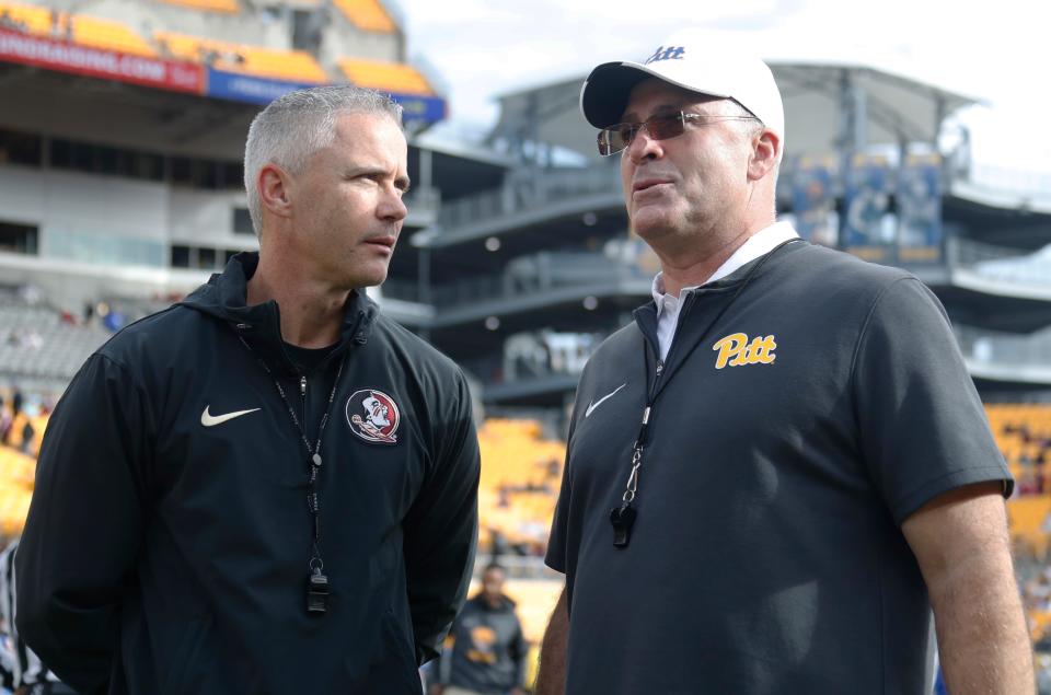 Florida State Seminoles head coach Mike Norvell (left) and Pittsburgh Panthers head coach Pat Narduzzi (right) meet at mid-field before their teams play Nov. 4, 2023, at Acrisure Stadium in Pittsburgh, Pennsylvania.