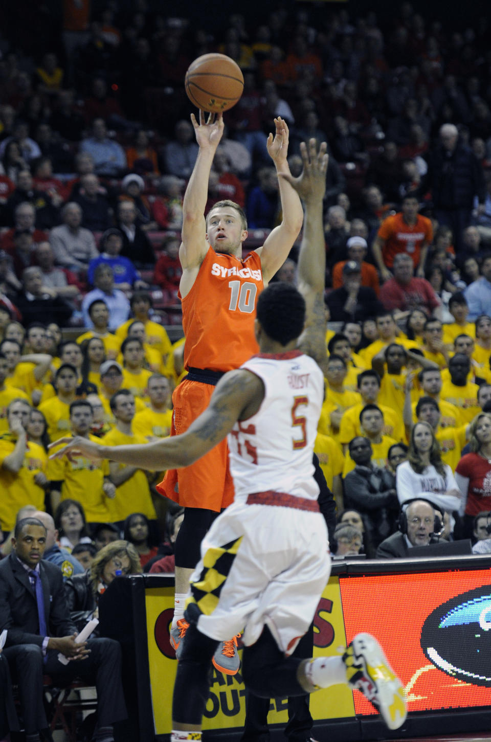 Syracuse guard Trevor Cooney (10) shoots as Maryland guard Nick Faust (5) defends during the first half of an NCAA college basketball game, Monday, Feb. 24, 2014, in College Park, Md. (AP Photo/Nick Wass)