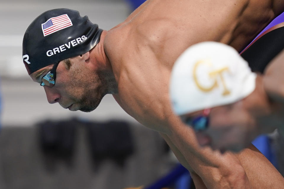 FILE - In this Sunday, April 11, 2021 file photo, Matt Grevers dives in to the pool at the start of the men's 100-meter freestyle final at the TYR Pro Swim Series swim meet in Mission Viejo, Calif. (AP Photo/Ashley Landis, File)