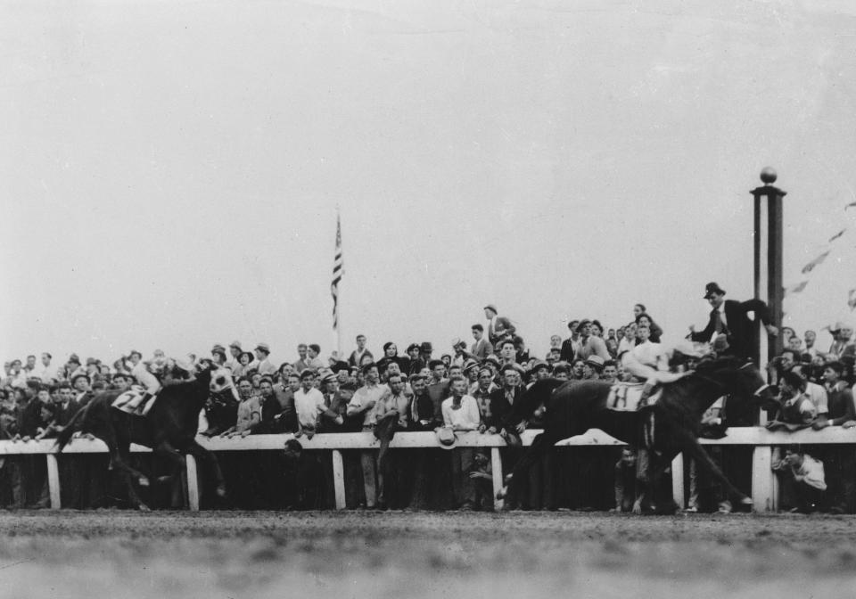 FILE - Cavalcade and jockey Mack Garner cross the finish line ahead of Discovery with jockey John Bejshak in the Kentucky Derby horse race at Churchill Downs in Louisville, Ky., May 5, 1934. (AP Photo)
