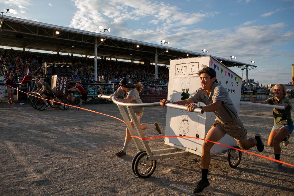 Members of the Walk, Trot, Canter 4-H Club (right) push their cart across the finish line and take first place in the annual Outhouse Race in front of the grandstands during the 4-H Night at the Ross County Fair on August 8, 2023 , in Chillicothe, Ohio.