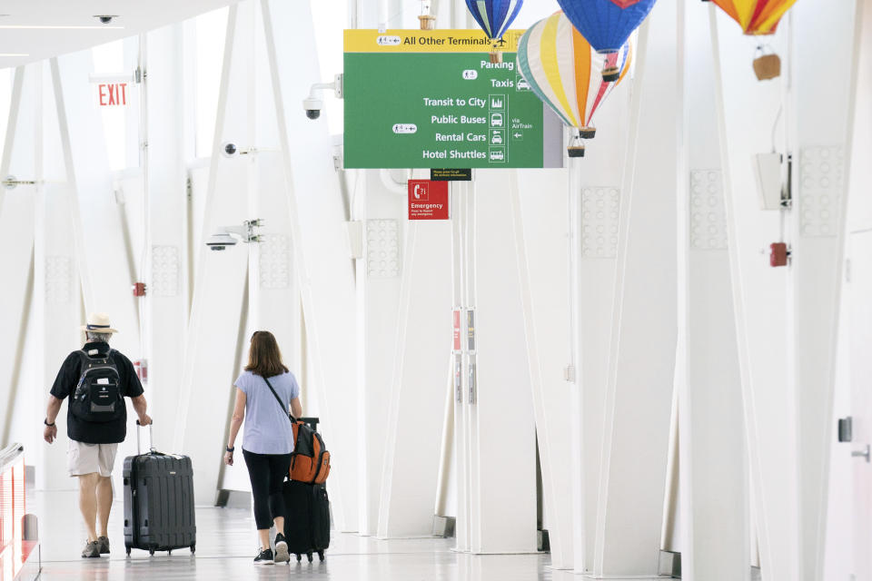 People walk through John F. Kennedy International Airport on Tuesday, June 28, 2022, in New York. (AP Photo/Julia Nikhinson)