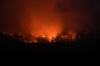 Seen in a long exposure photograph, the Soberanes Fire burns along ridges above Carmel-By-The-Sea, California, U.S. July 27, 2016. REUTERS/Noah Berger