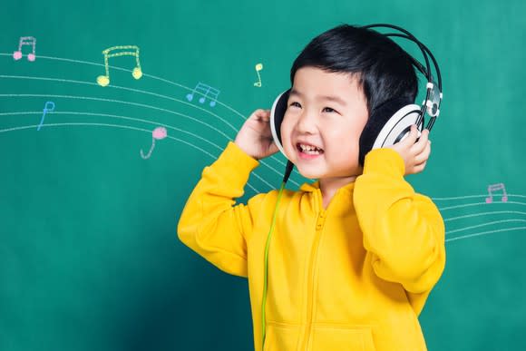 Chinese boy listening to music on headphones