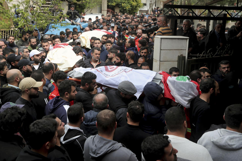 People carry the coffins of paramedics who were killed in an Israeli airstrike, during a funeral procession in Hebbariye village, south Lebanon, Wednesday, March 27, 2024. The Israeli airstrike on a paramedic center linked to a Lebanese Sunni Muslim group killed several of its members. The strike was one of the deadliest single attacks since violence erupted along the Lebanon-Israel border more than five months ago. (AP Photo/Mohammed Zaatari)