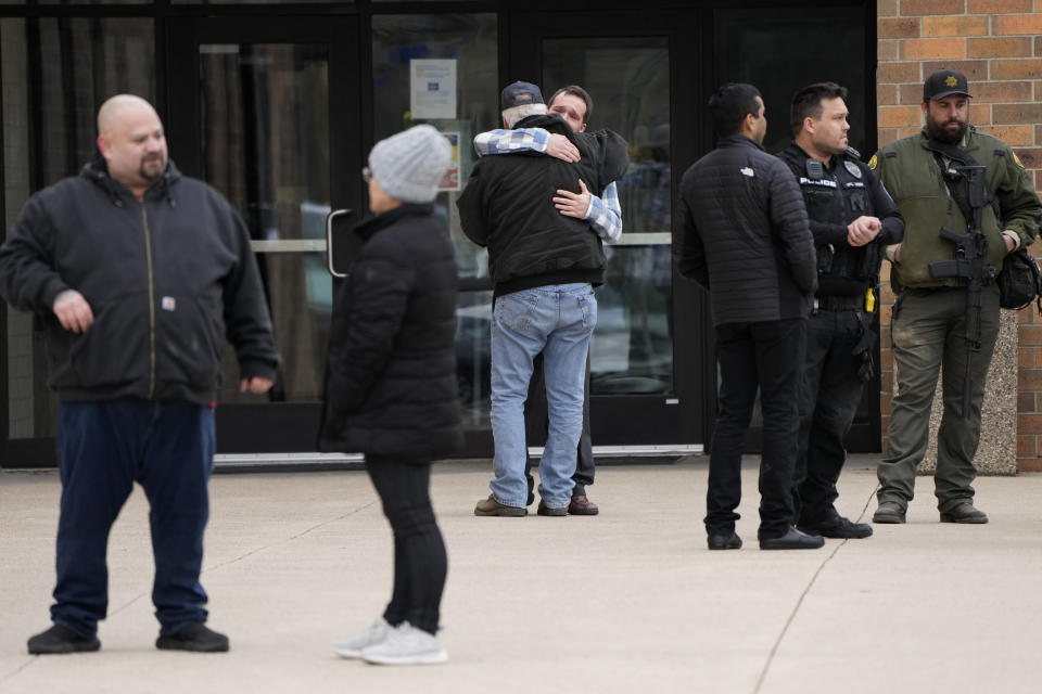 People embrace outside the McCreary Community Building where families are being reunited following a shooting at Perry High School, Thursday, Jan. 4, 2024, in Perry, Iowa. (AP Photo/Charlie Neibergall)