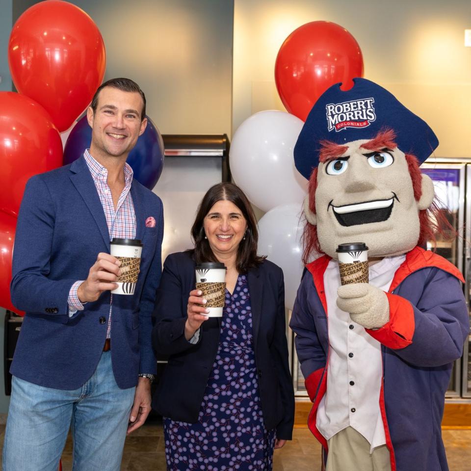 Robert Morris University has partnered with Saxbys to offer new opportunities, and dining options, to students this fall. Pictured, from left to right: Nick Bayer, founder and CEO of Saxbys, Michelle Patrick, president of Robert Morris University, and the mascot "RoMo."