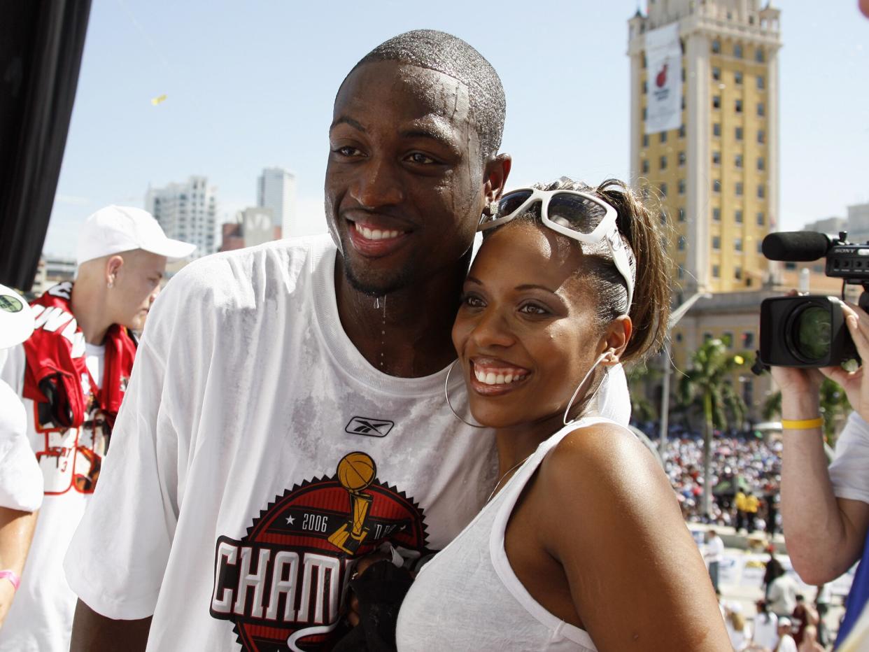 Dwyane Wade of the Miami Heat poses for a photo with wife Siohvaughn, during the Heats NBA championship victory parade at American Airlines Arena on June 23, 2006 in Miami, Florida