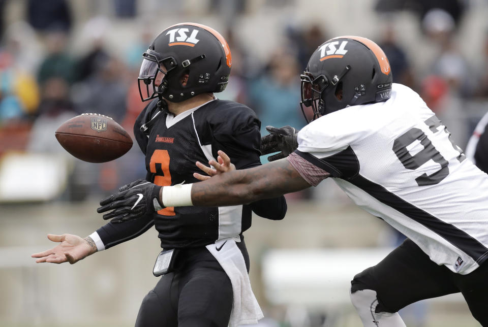 Kona Schwenke (R) forces former Heisman Trophy-winning quarterback Johnny Manziel to fumble during a developmental Spring League football game, Saturday, April 7, 2018, in Austin, Texas. (AP Photo/Eric Gay)