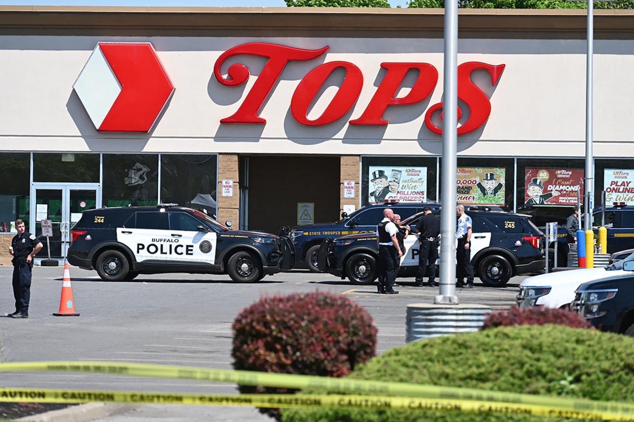 Police sit in front of a Tops Grocery store in Buffalo, New York, on May 15, 2022.