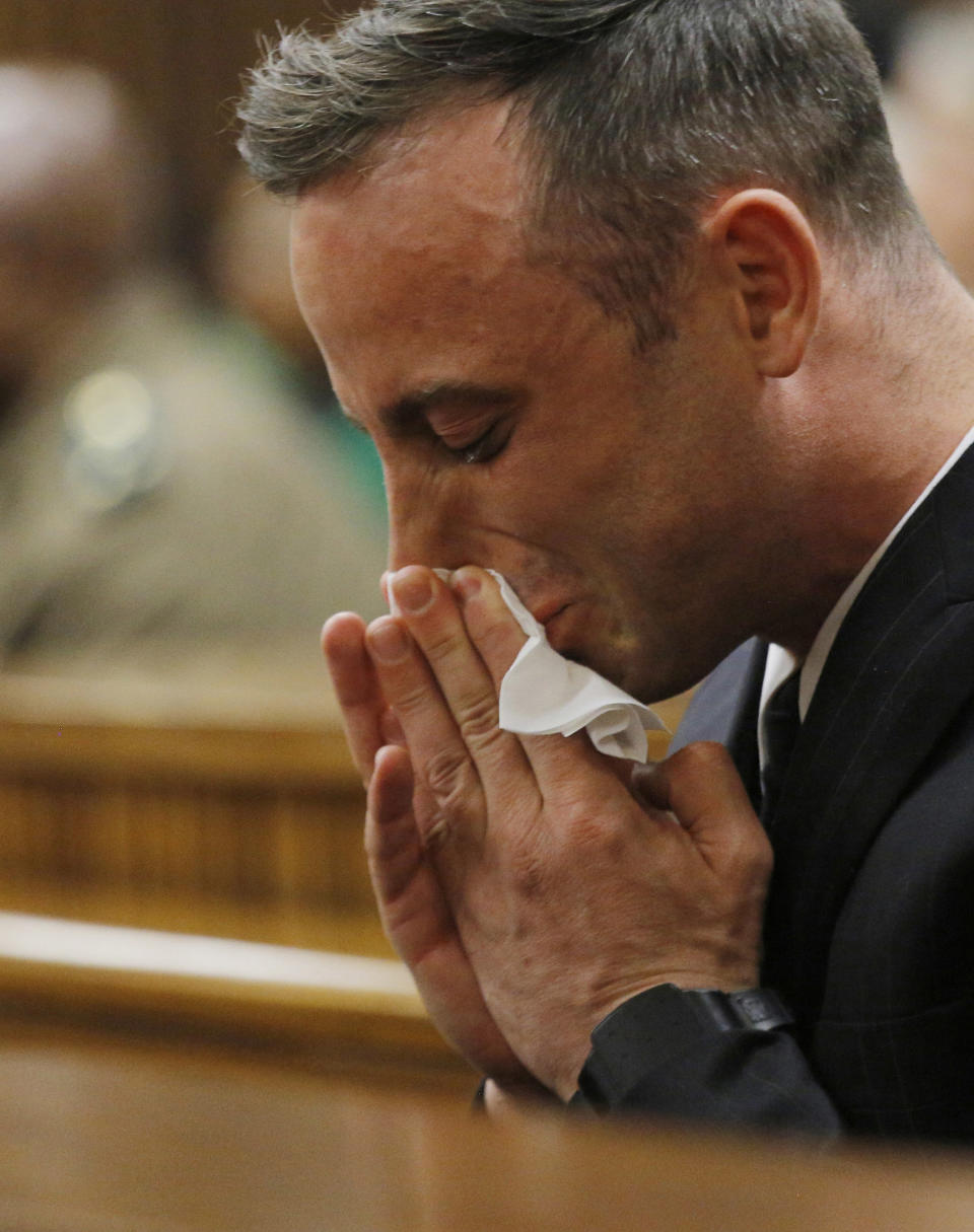 FILE - Oscar Pistorius wipes his face as he appears in the High Court in Pretoria, South Africa on the second day of his sentencing hearing for murdering girlfriend Reeva Steenkamp June 14, 2016. Pistorius shot his girlfriend Reeva Steenkamp more than a decade ago in a Valentine's Day killing that jolted the world and shattered the image of a sports superstar. (Kim Ludbrook/ Pool Photo via AP, File)