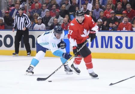 Sep 27, 2016; Toronto, Ontario, Canada; Team Canada center Patrice Bergeron (37) is defended by Team Europe center Anze Kopitar (11) during the first period in game one of the World Cup of Hockey final at Air Canada Centre. Mandatory Credit: Dan Hamilton-USA TODAY Sports