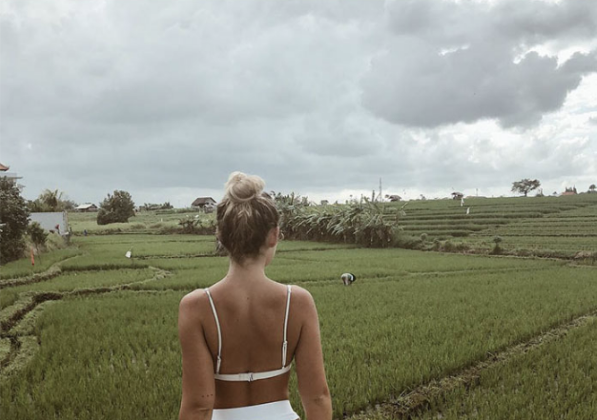 Social media influencer Natalie Schlater posed in a rice field wearing a bikini and mused about life as a field worker in Bali. 