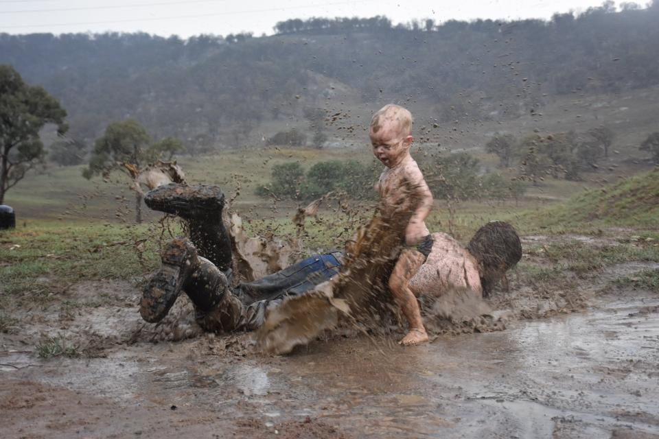 NSW boy Archie Saunders experiences the largest rainfall of his life with his dad.