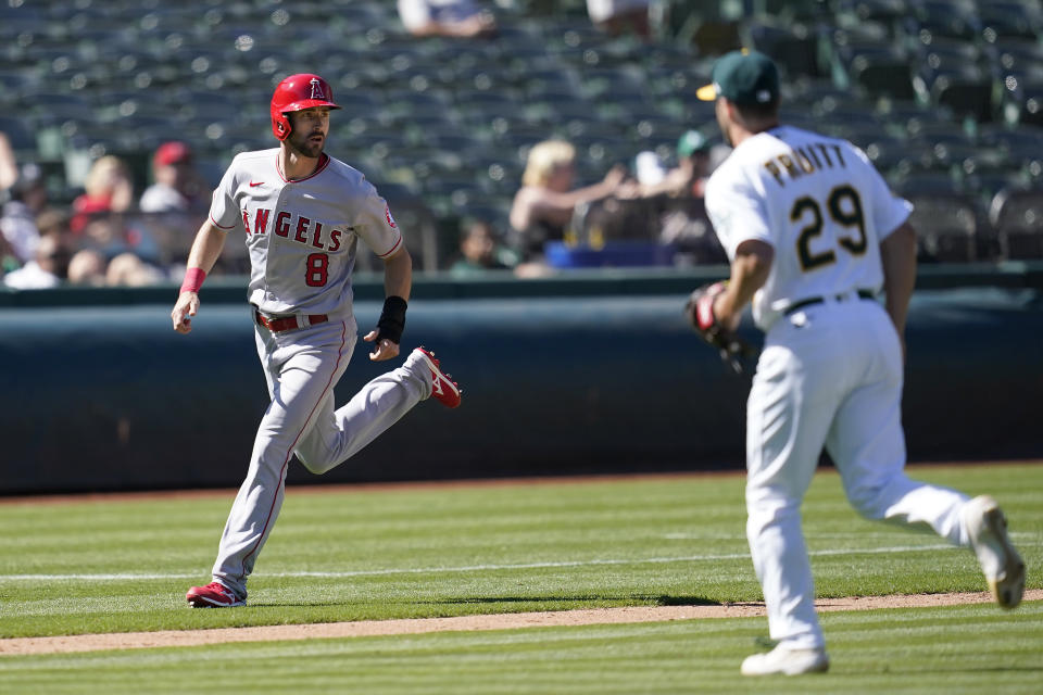 Los Angeles Angels' Steven Duggar (8) runs home to score past Oakland Athletics pitcher Austin Pruitt (29) during the twelfth inning of a baseball game in Oakland, Calif., Wednesday, Aug. 10, 2022. (AP Photo/Jeff Chiu)