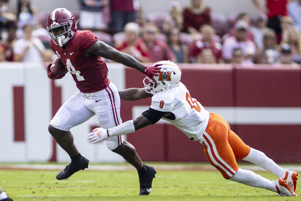 Alabama running back Brian Robinson Jr. (4) runs past Mercer defensive back Lance Wise (0) during the first half of an NCAA college football game, Saturday, Sept. 11, 2021, in Tuscaloosa, Ala. (AP Photo/Vasha Hunt)